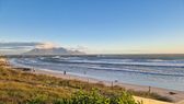 View from the dunes at Big Bay across the surf to Table Mountain